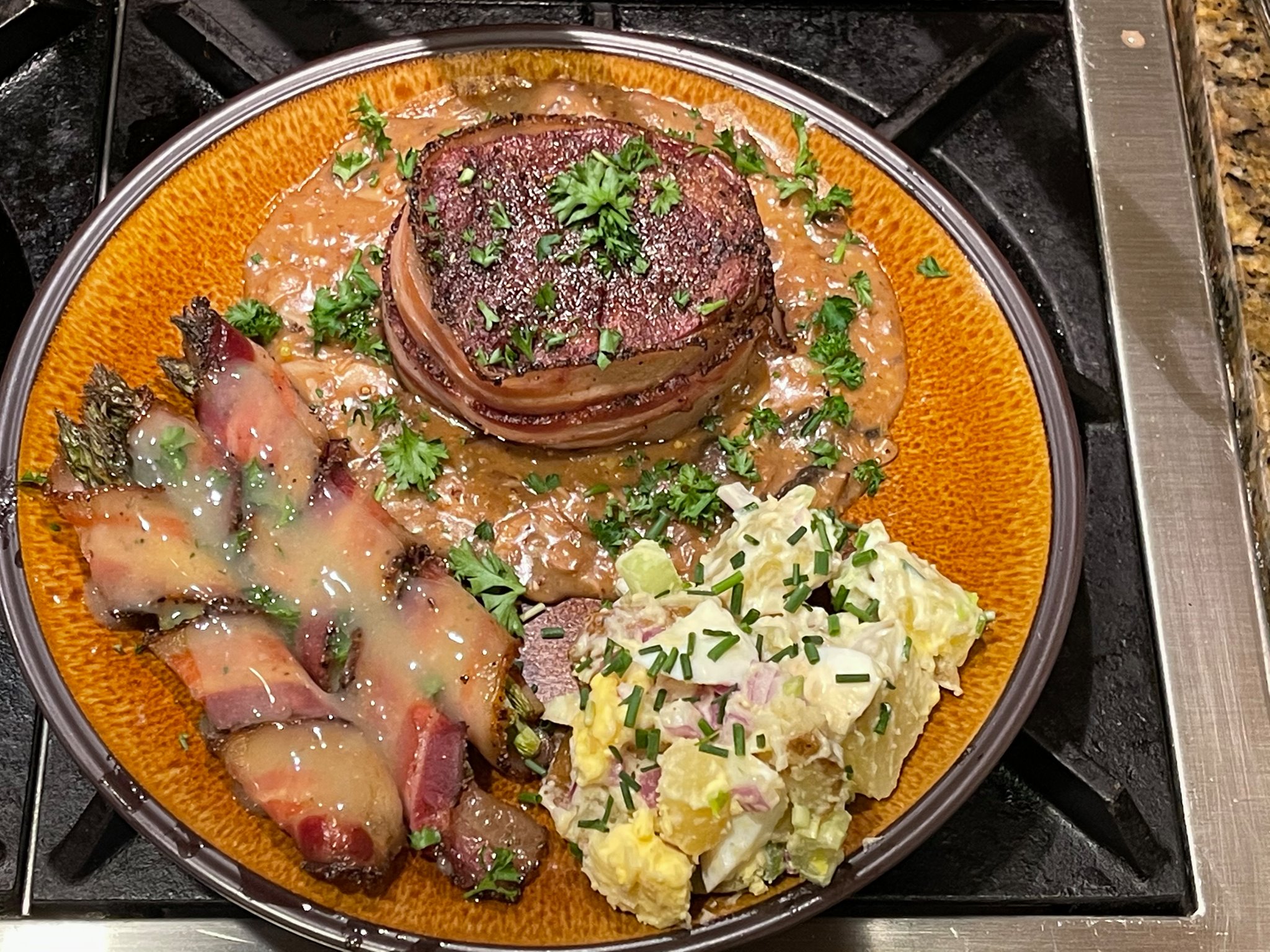 Smoked bacon-wrapped filet mignon set in a cognac-cream-mushroom sauce…